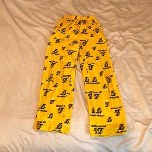 Small yellow Lakers pajama pants with dark blue writing